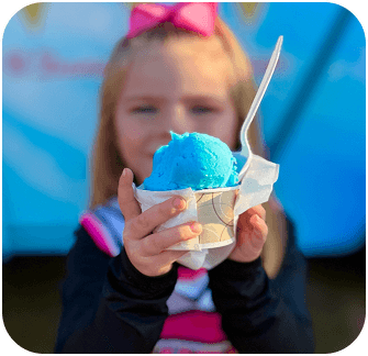 Two ice cream trucks parked